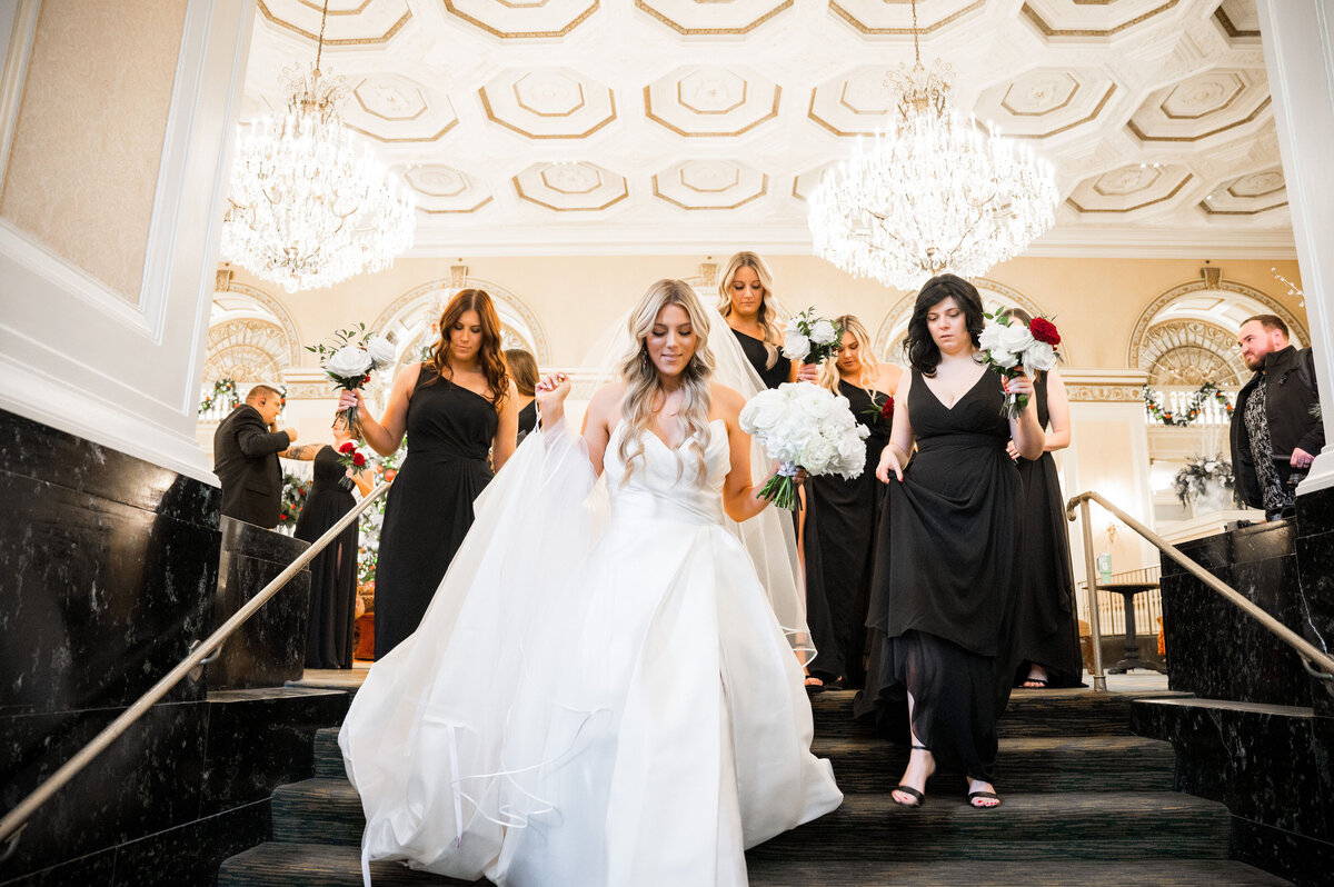 bride walking out of the hotel to her wedding ceremony