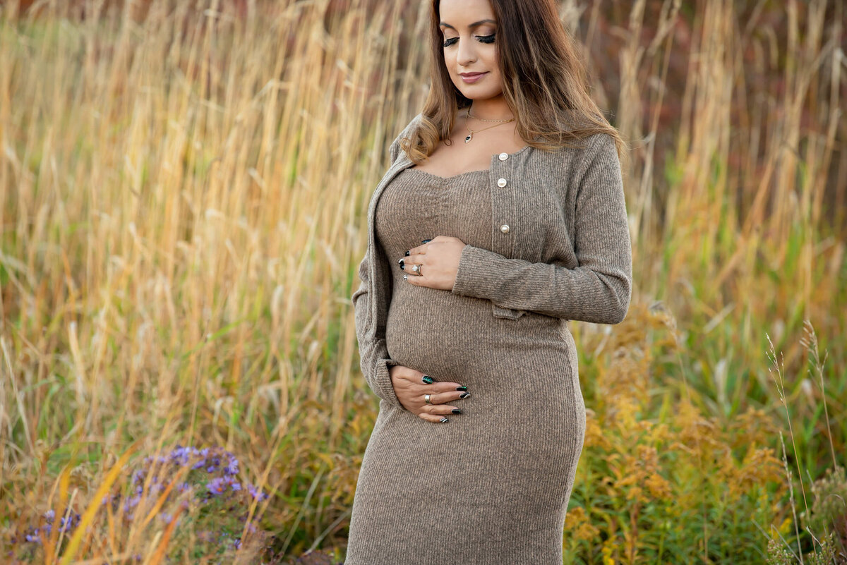 pregnant woman wearing a beige dress for her Burlington, Ontario fall maternity photography session