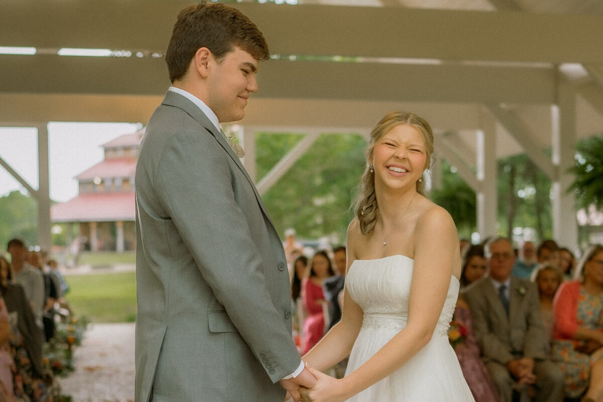 groom and bride smiling with joy during their wedding ceremony