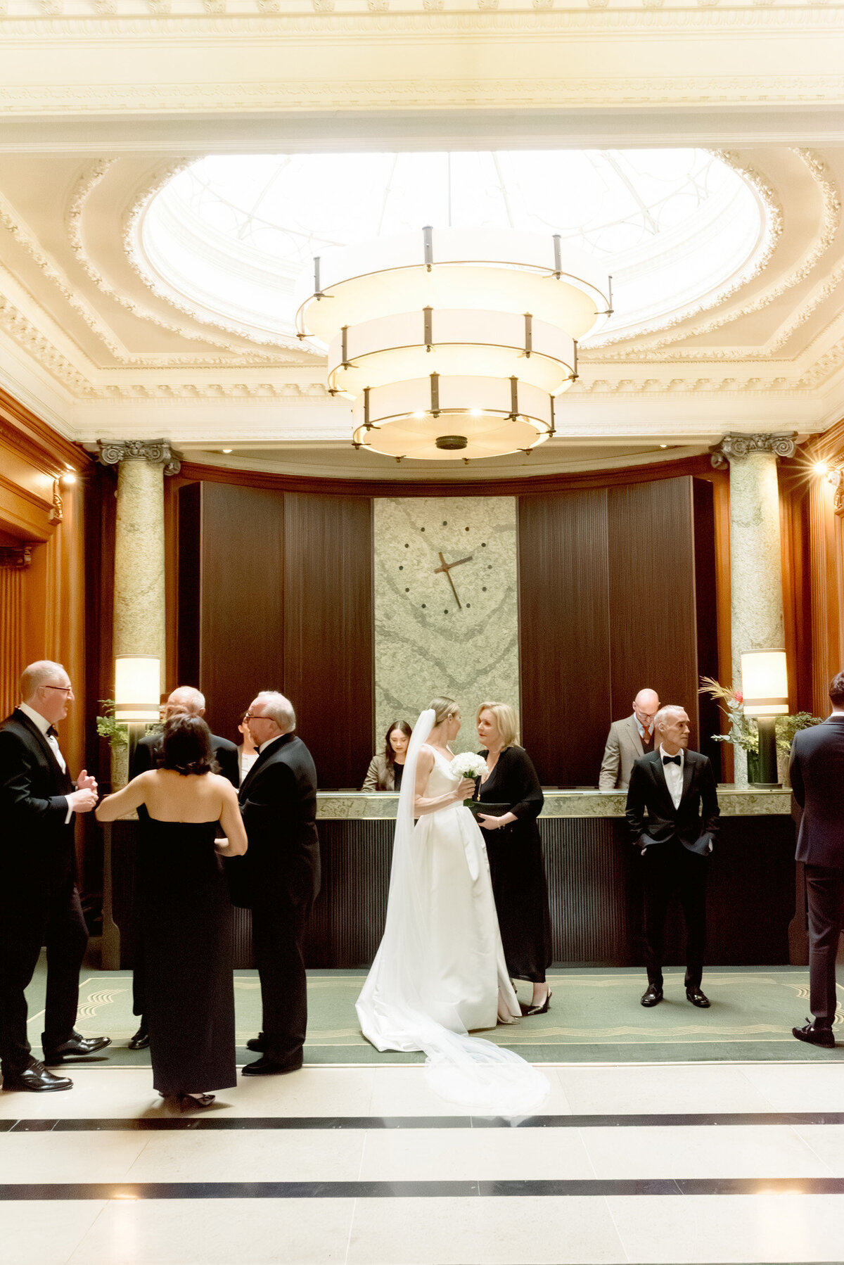 Guests gather in the lobby of Gleneagles hotel on a black tie wedding day.  Image by Scotland wedding photographer, Jill Cherry Porter.