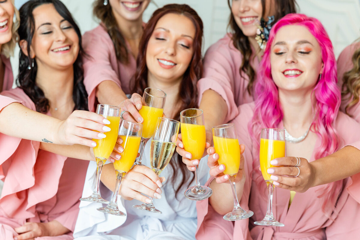 bride and bridesmaids toasting before getting ready