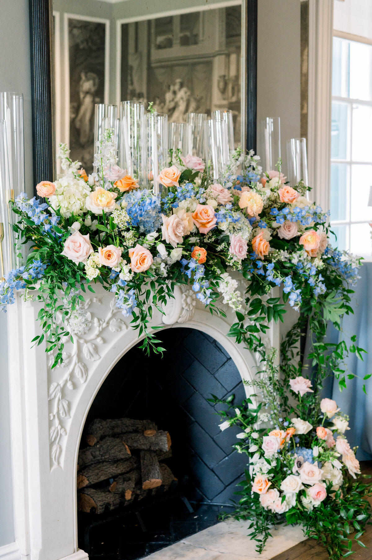 Reception fireplace decorated with colorful summer florals at University Club wedding