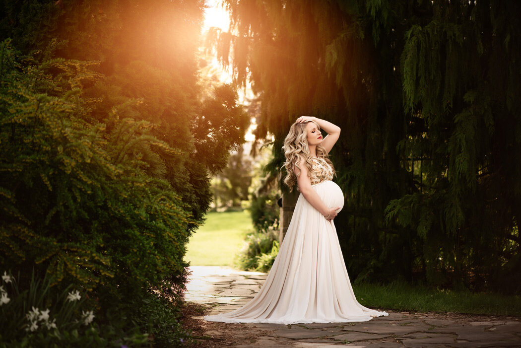 Grand Rapids Maternity Photography Mom Holding belly in White maternity gown by For The Love Of Photography