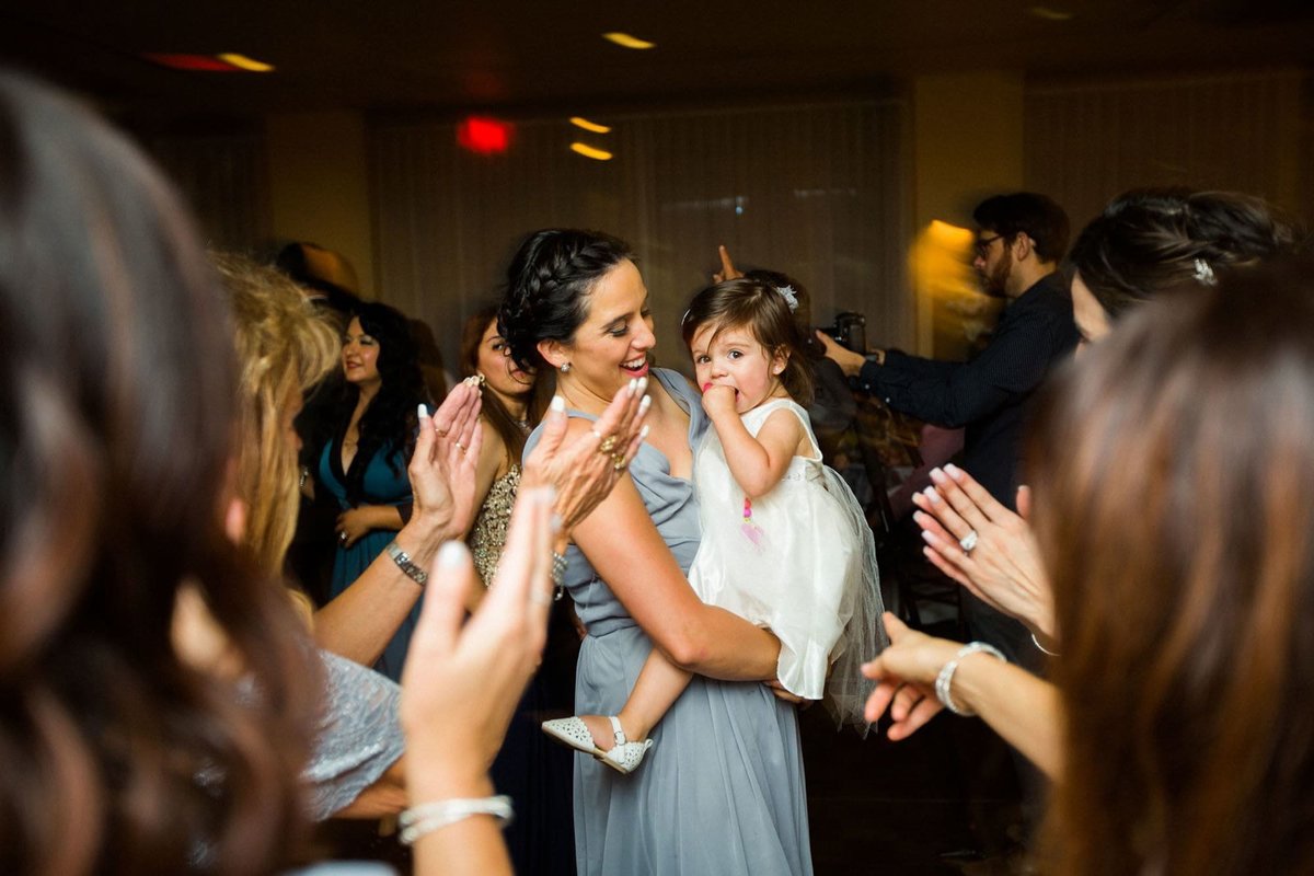 Bridesmaid dances with her baby girl
