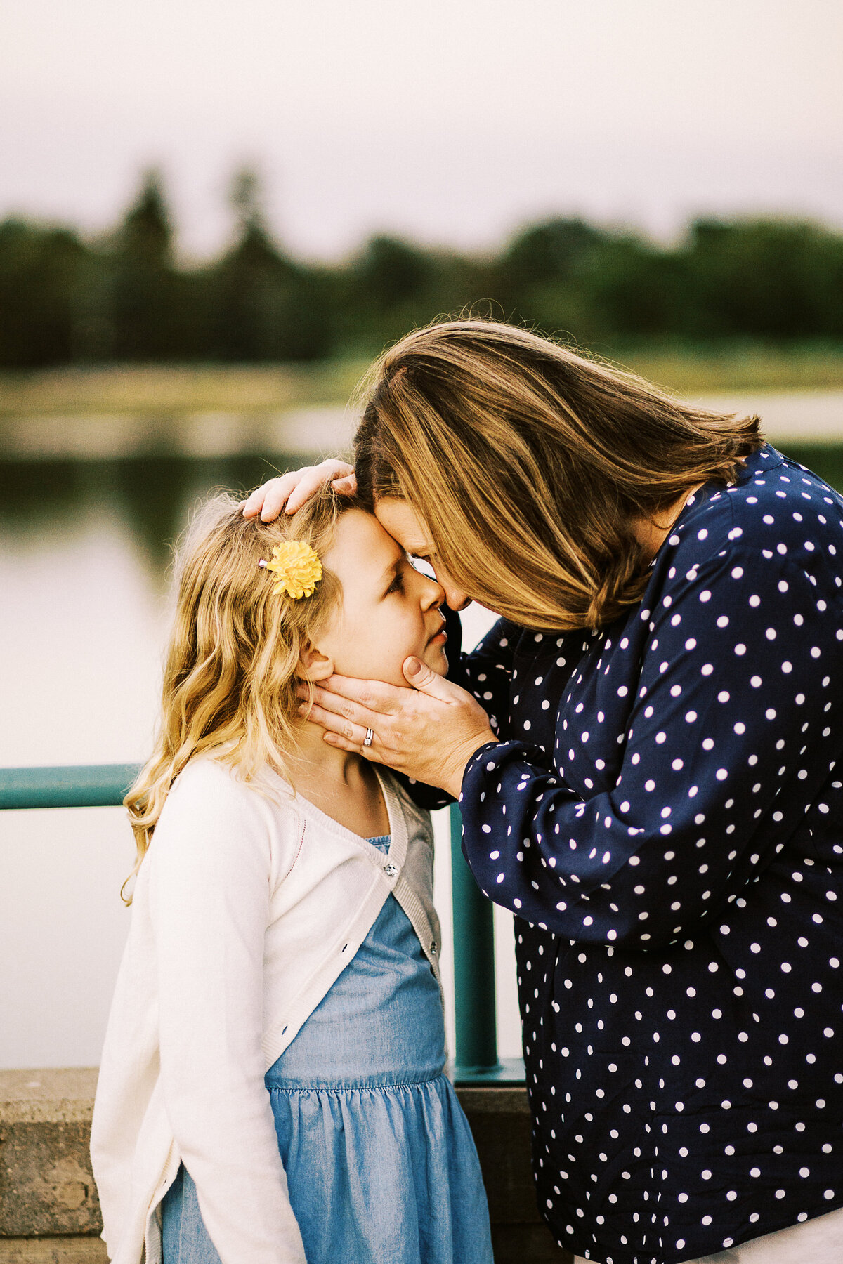 mom and daughter touch noses and look at each other