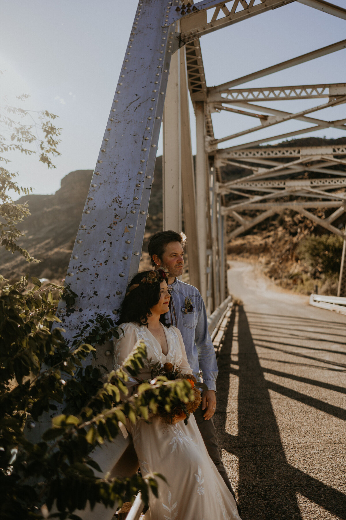 newlyweds standing on a bride above the Rio Grade in New Mexico