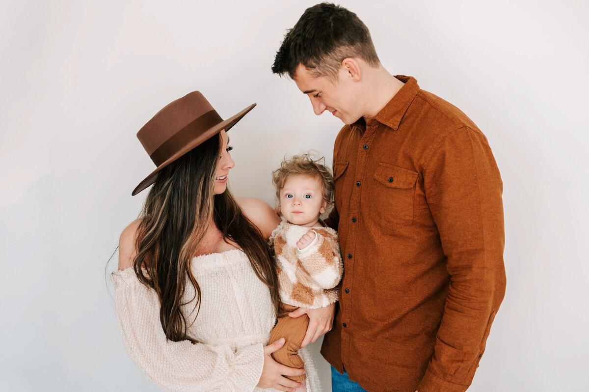 family photo of parents holding baby boy in family photography studio in Branson