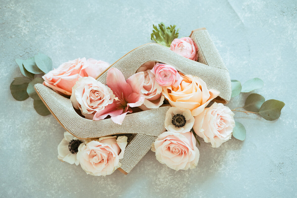 Detail shot of roses with brides shoes