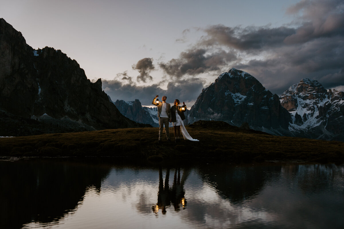 Romantic reflection of couple in mountain lake after sunset