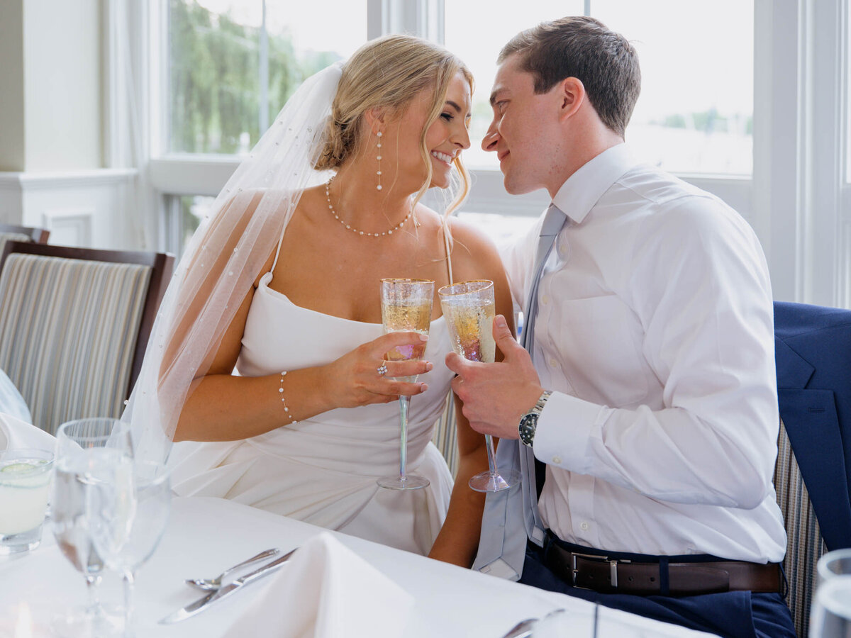 Bride and groom toasting at their Cleveland Yachting Club wedding reception