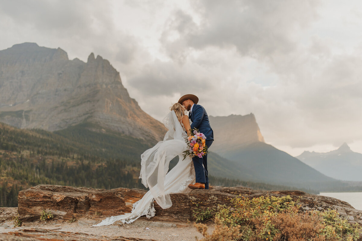 Bride and Groom elope in Glacier national park with mountains behind them