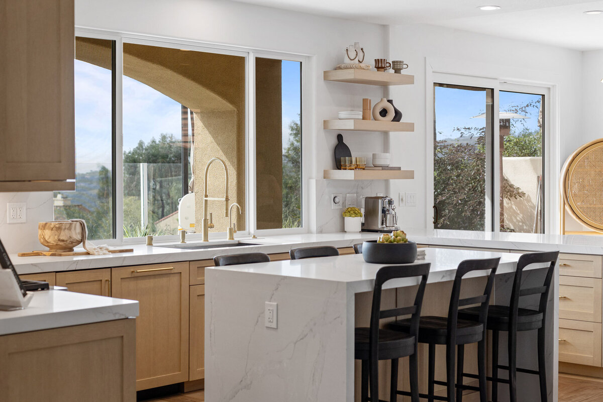 This kitchen is a testament to modern design. Clean lines, muted wood tones, and advanced appliances come together to create a space that's both stylish and functional.
