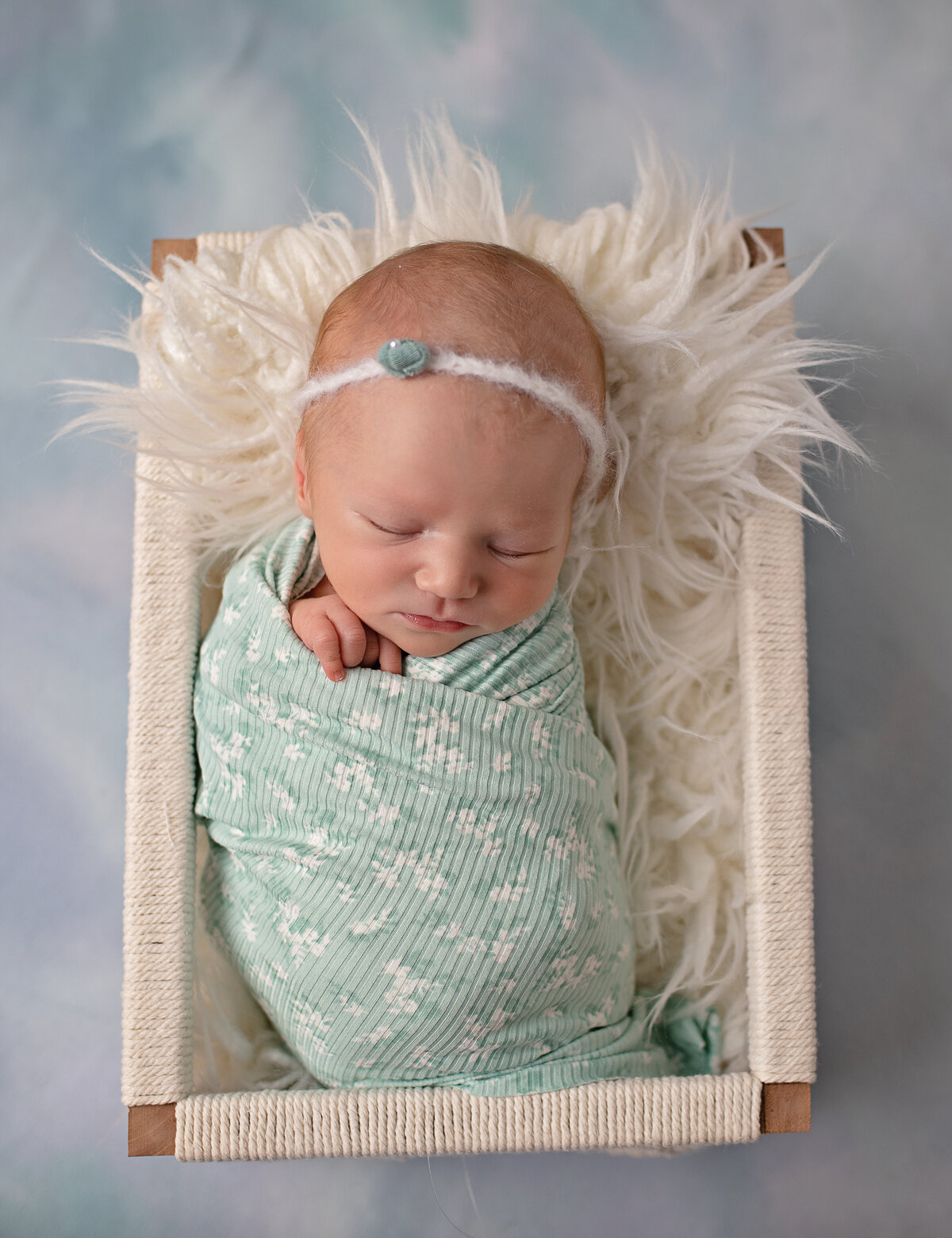 baby in basket teal