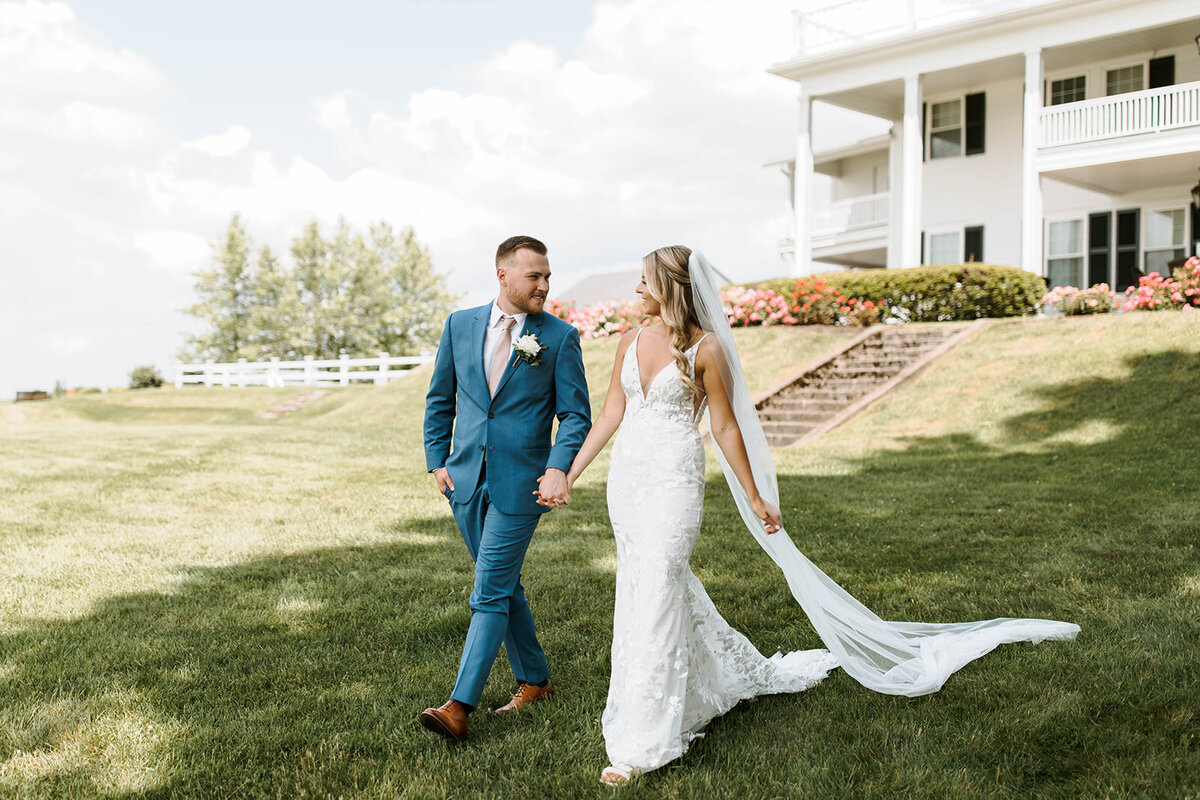 bride and groom walking estate property in upstate new york