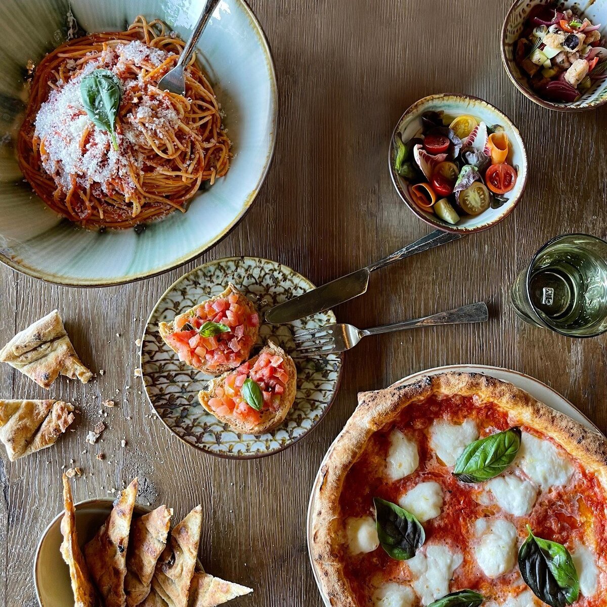 An overhead view of the margherita pizza and spaghetti pomodoro at the rustic chic restaurant within Borgo Santo Pietro