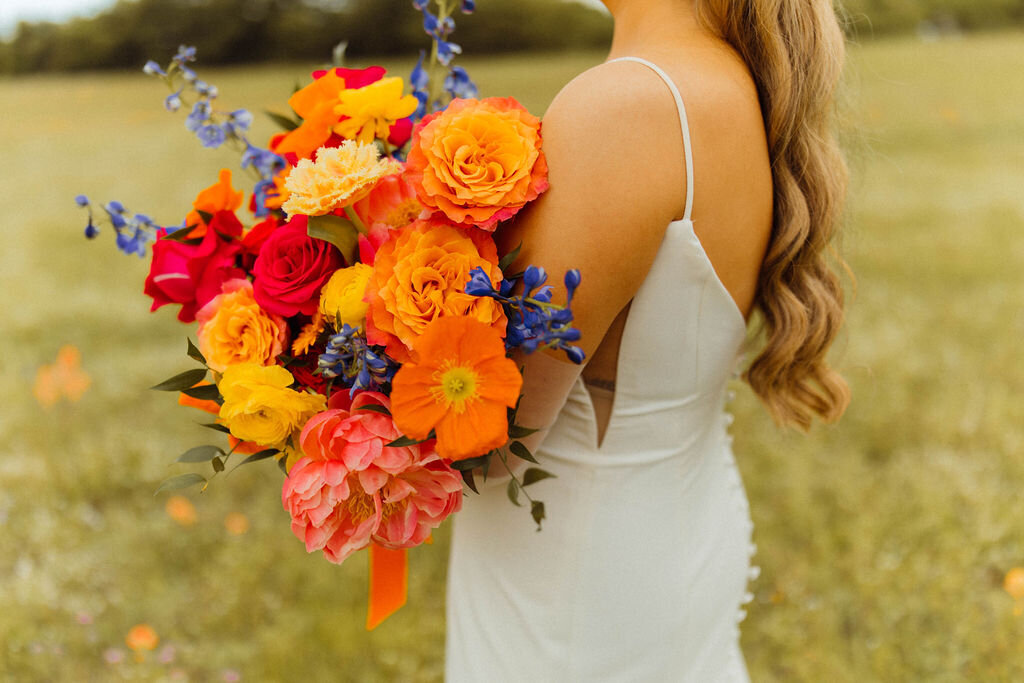 Striking bridal bouquet featuring vibrant blooms and sculptural elements, designed for a high-impact wedding in Dallas.