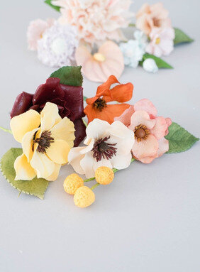 elegant luxury sugar flowers for garden inspired wedding cakes featuring winter jewel tones with burgundy roses, cream and yellow ranunculus, orange cosmos, yellow craspedia, and peach ranunculus - sugar flowers by kelsie cakes