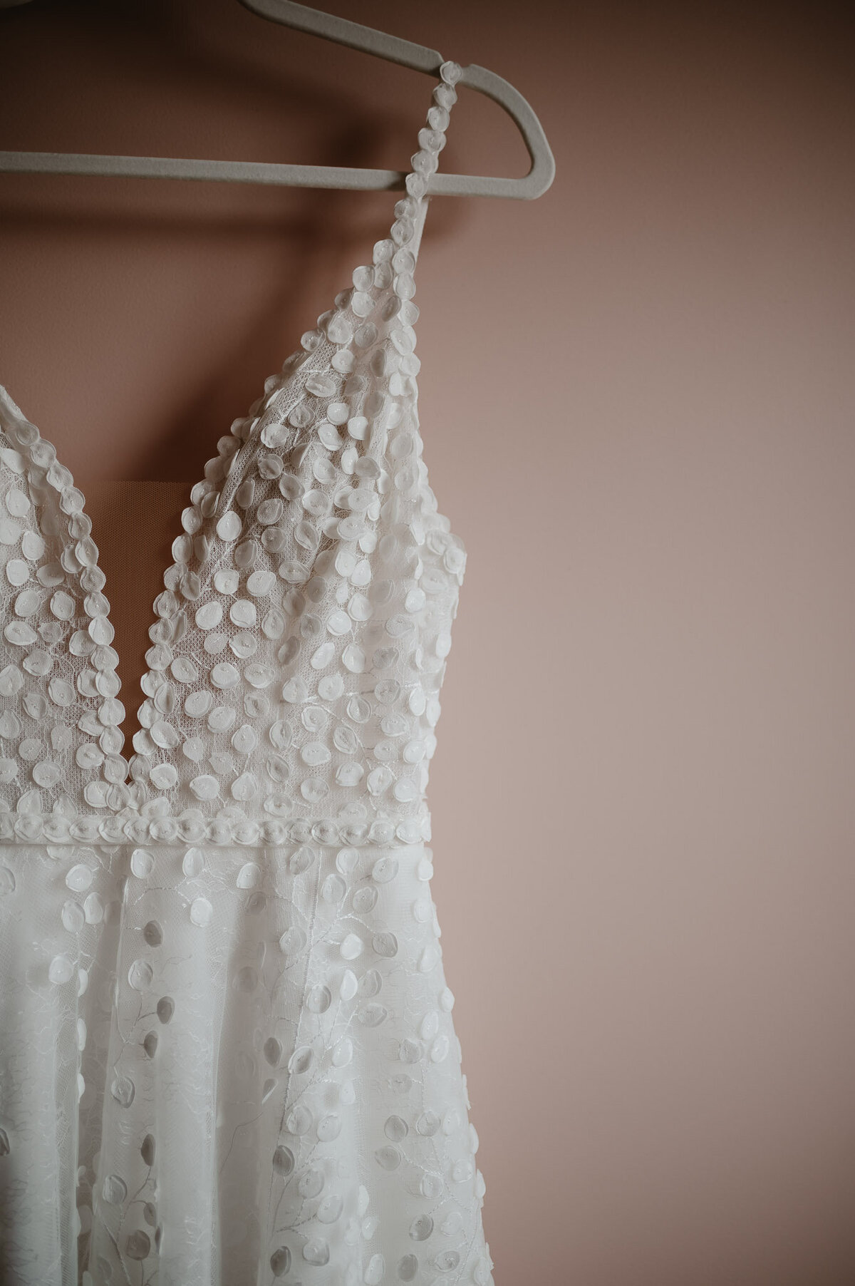 white bridal dress with a pink background