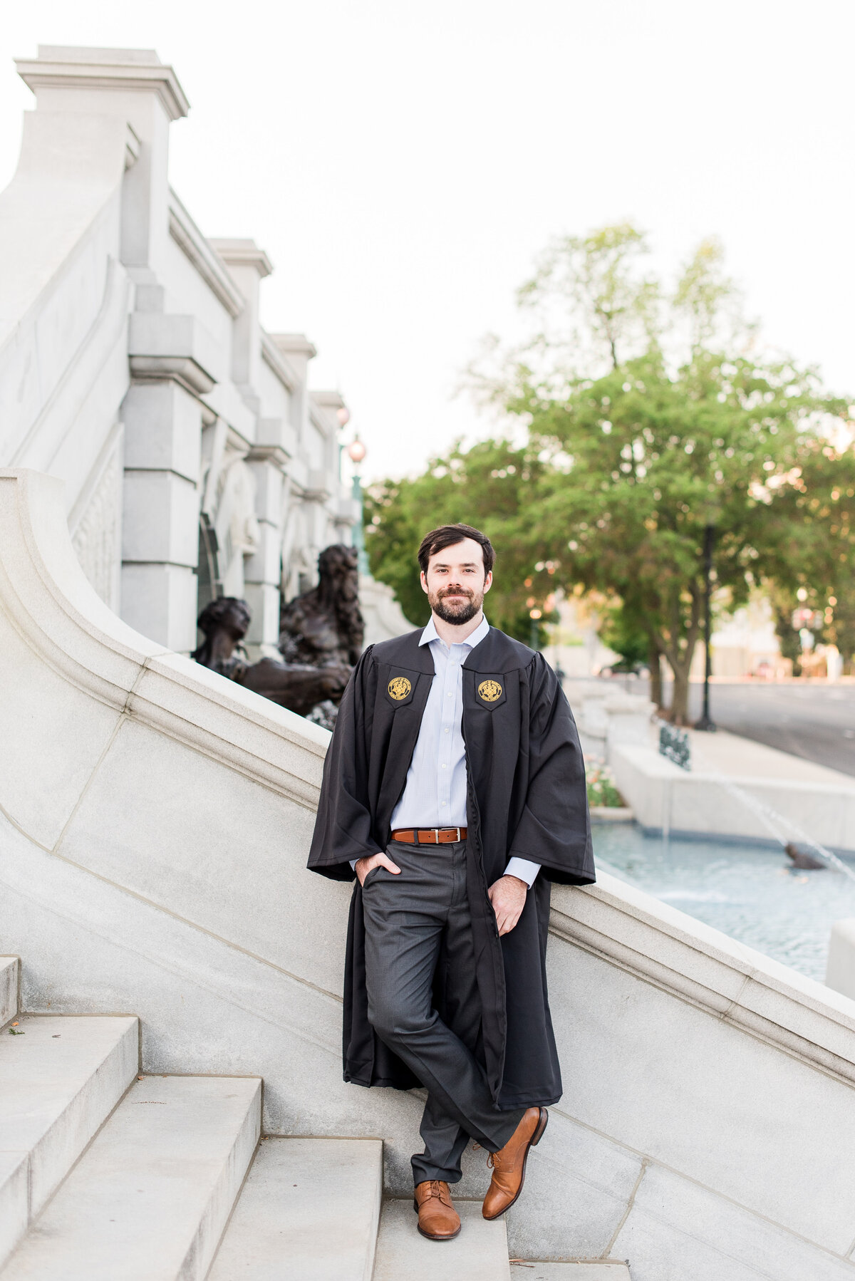 male grad on marble steps