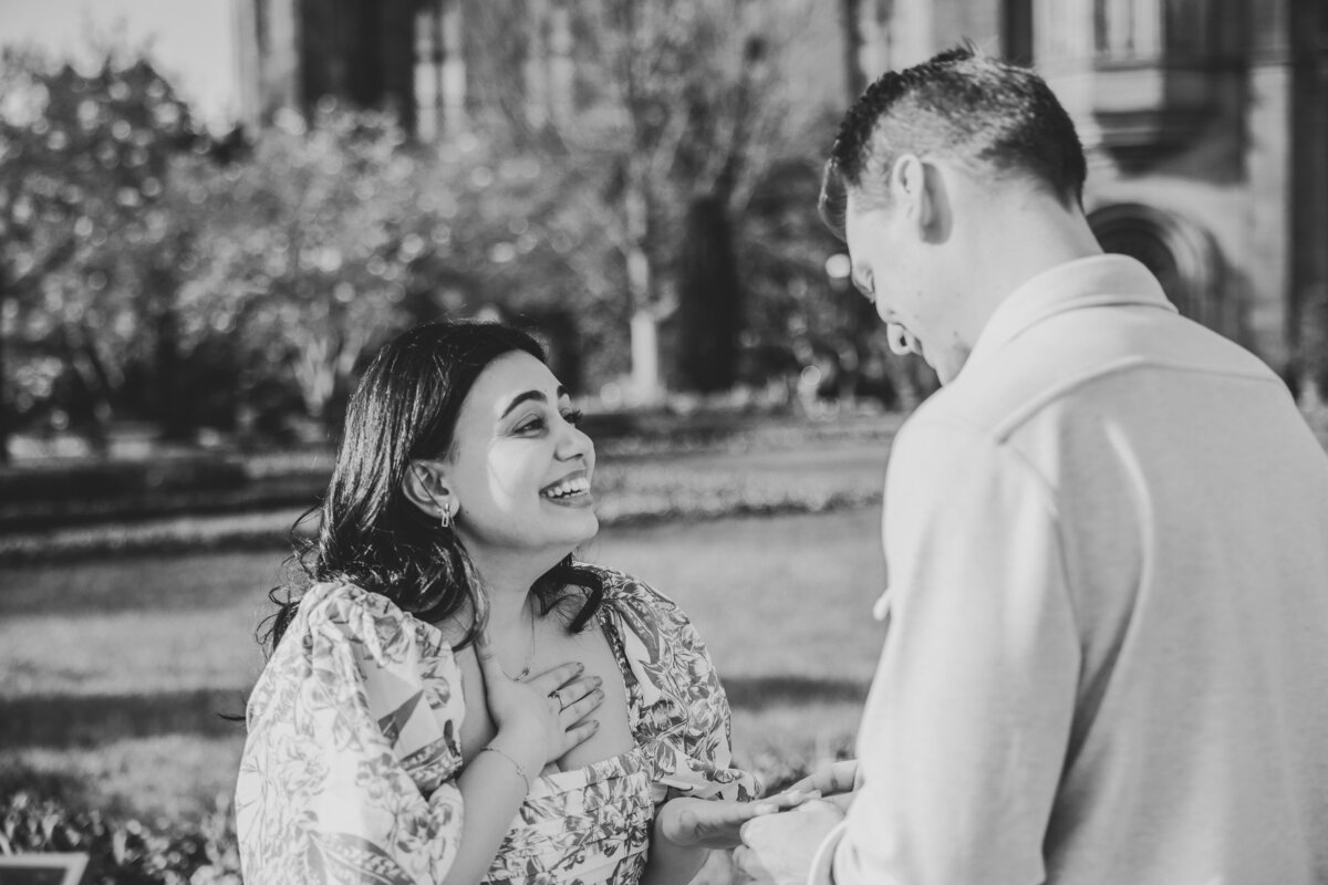 A couple smiles at one another at their Smithsonian Castle proposal.