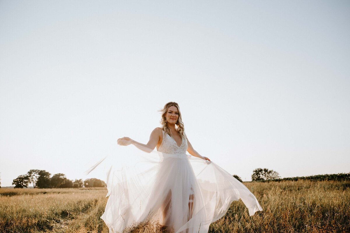 Bride standing in field in Exeter, Ontario