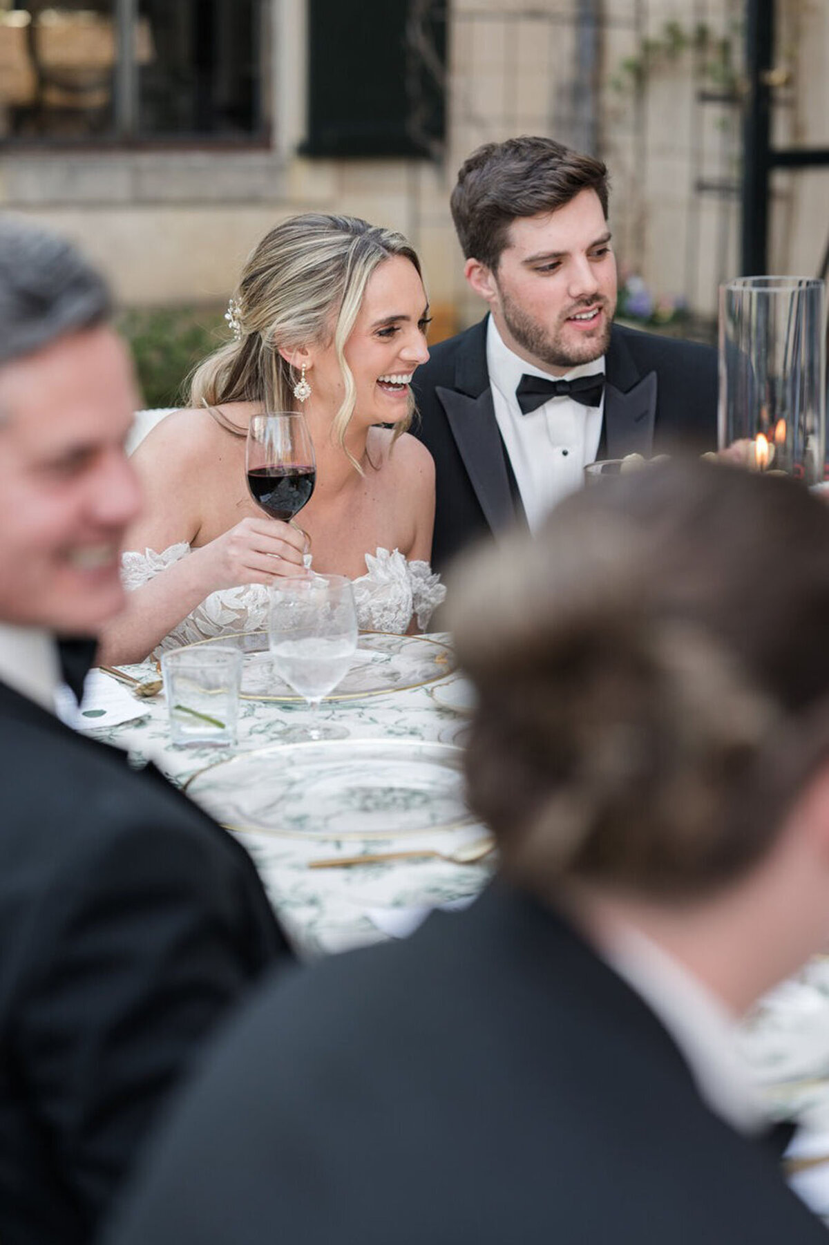 Bride and groom holding drinks at wedding reception, taken by wedding photographer in Cincinnati, OH