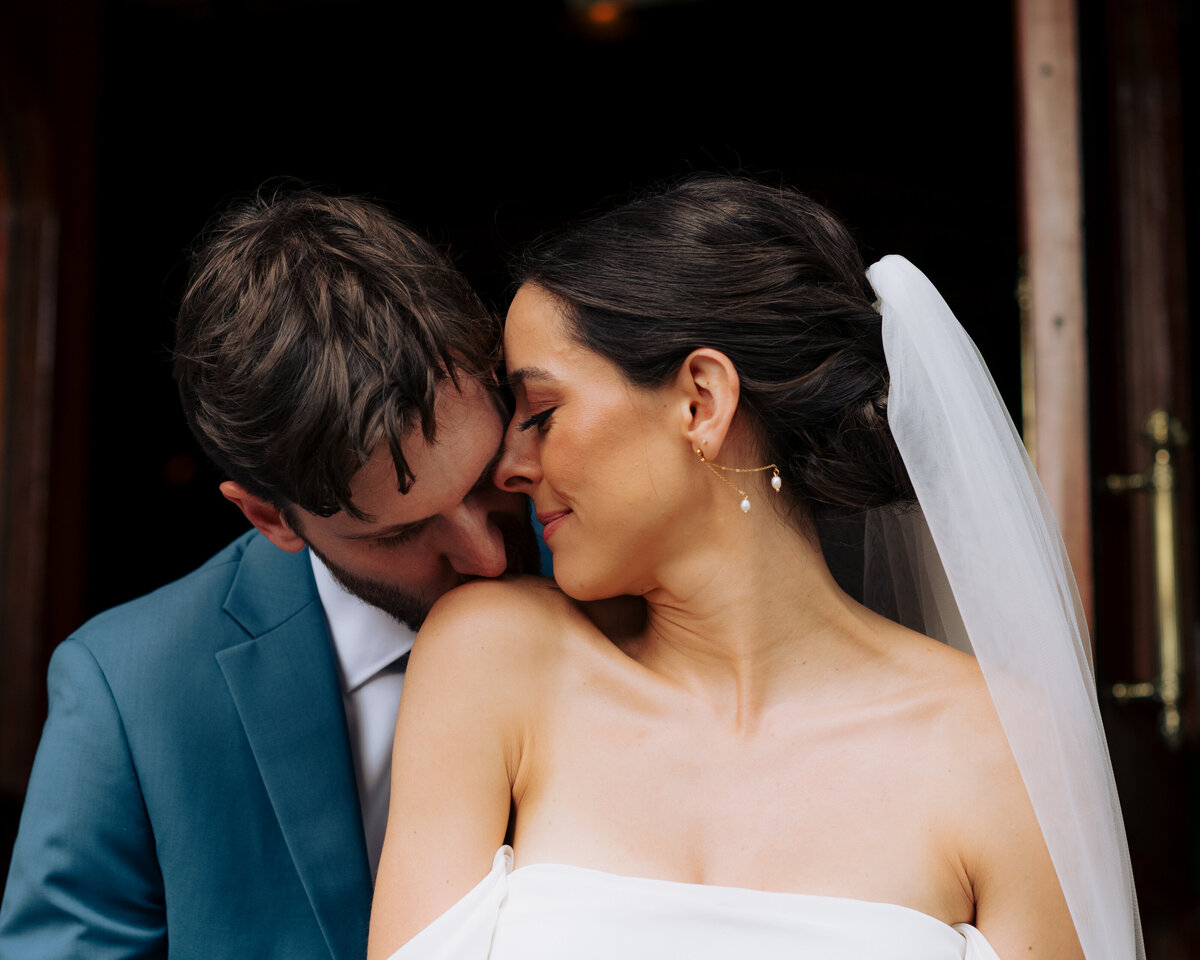 Documentary-style photo of couple kissing during wedding at the Bohlin in Newport