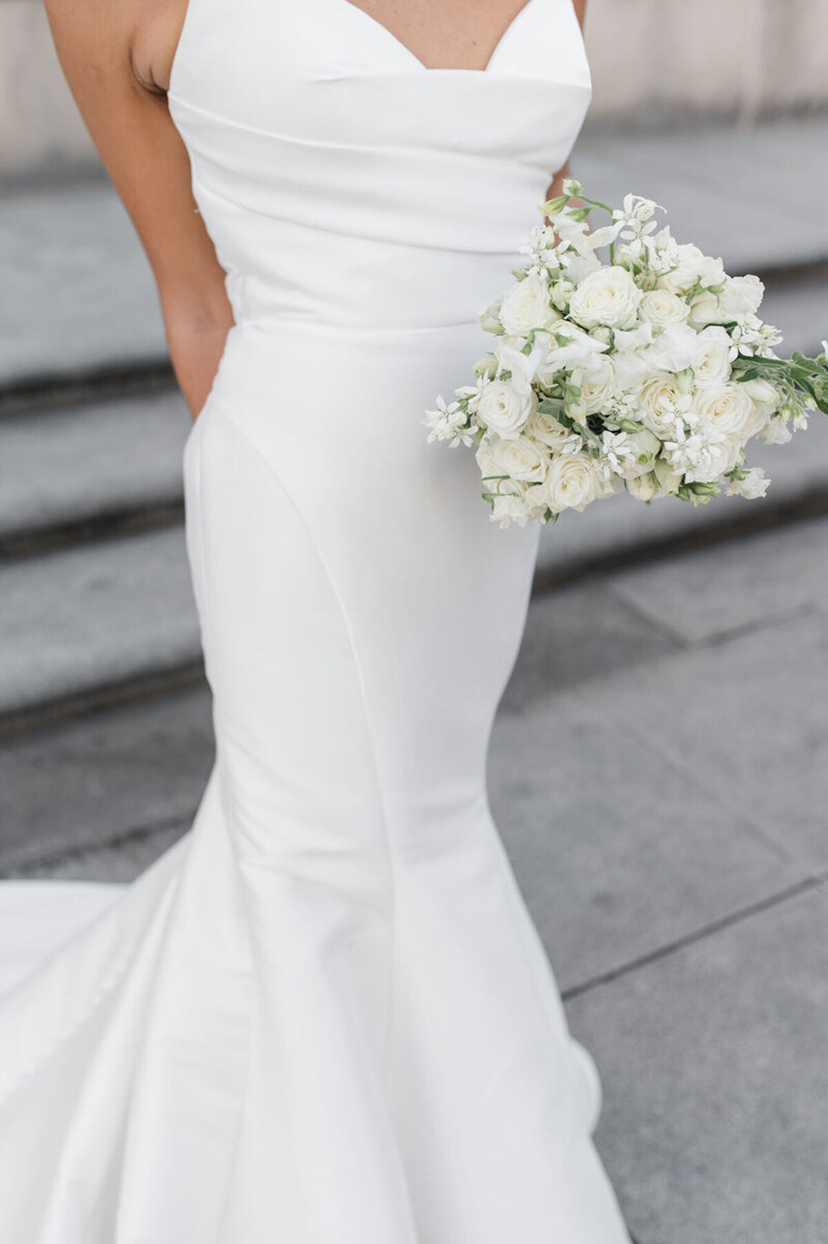 Bride holding floral arrangement at Cincinnati wedding, photographed by Courtney Rudicel