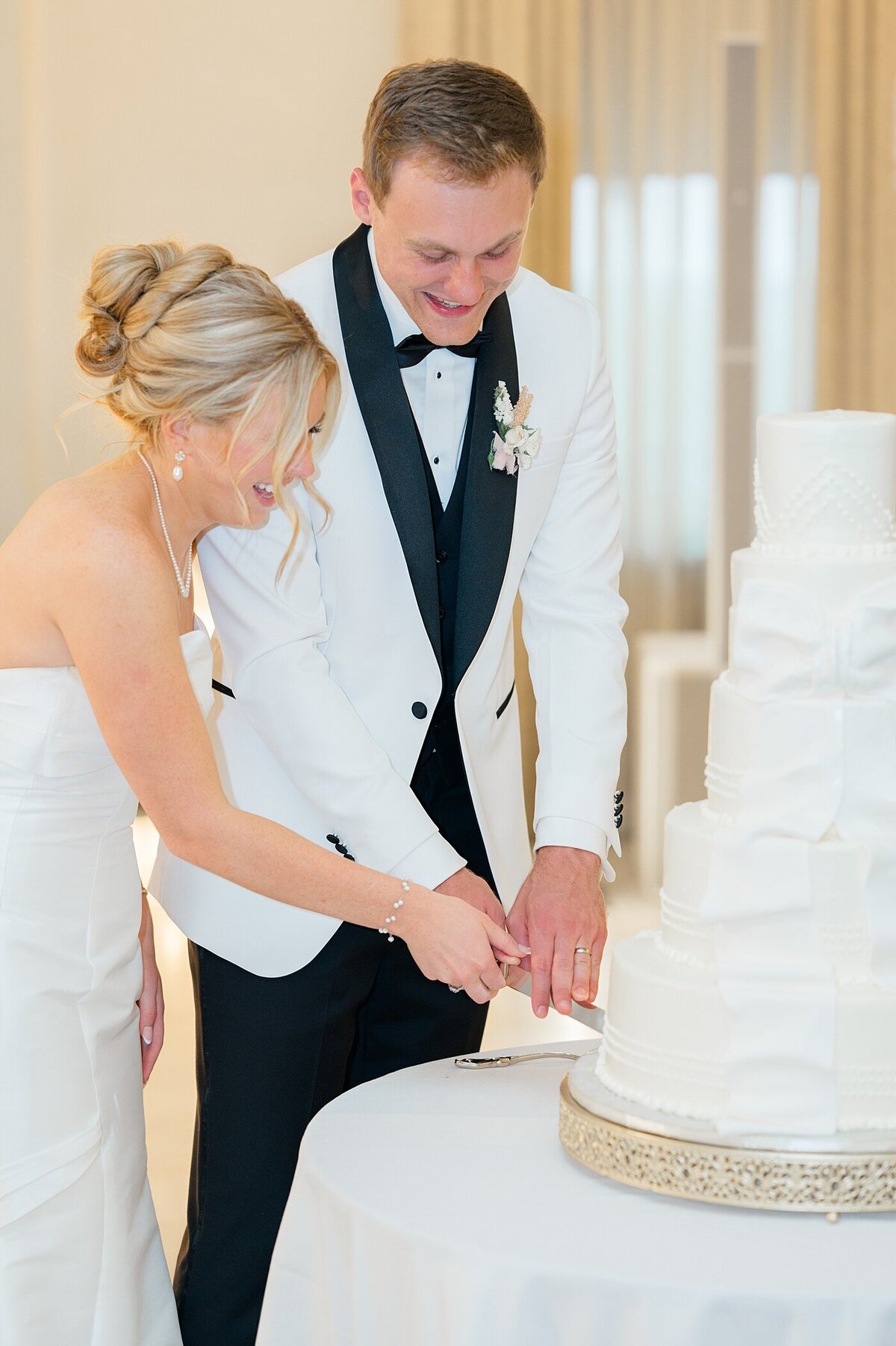 the Westin wedding reception with bride and groom cutting their cake together during their reception