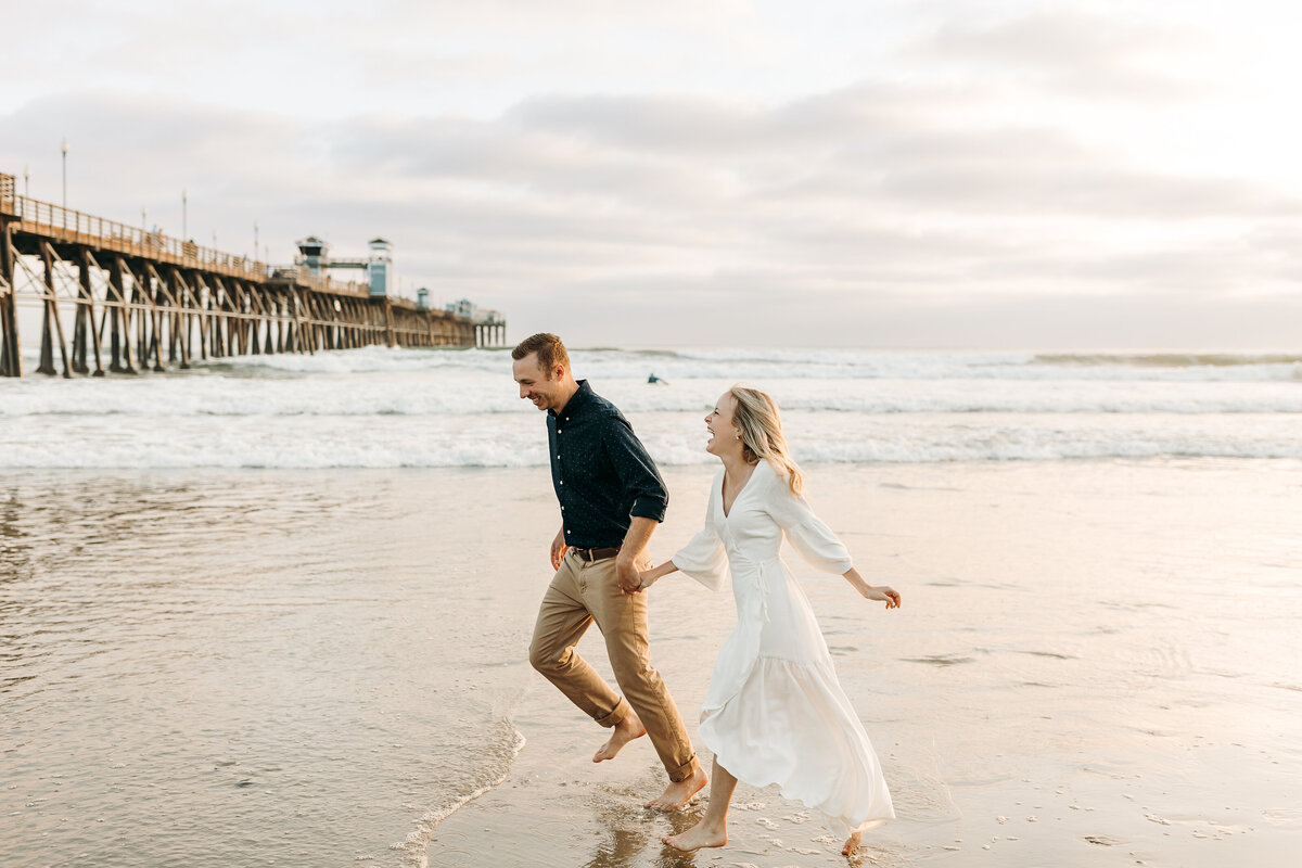 A couple running on the beach