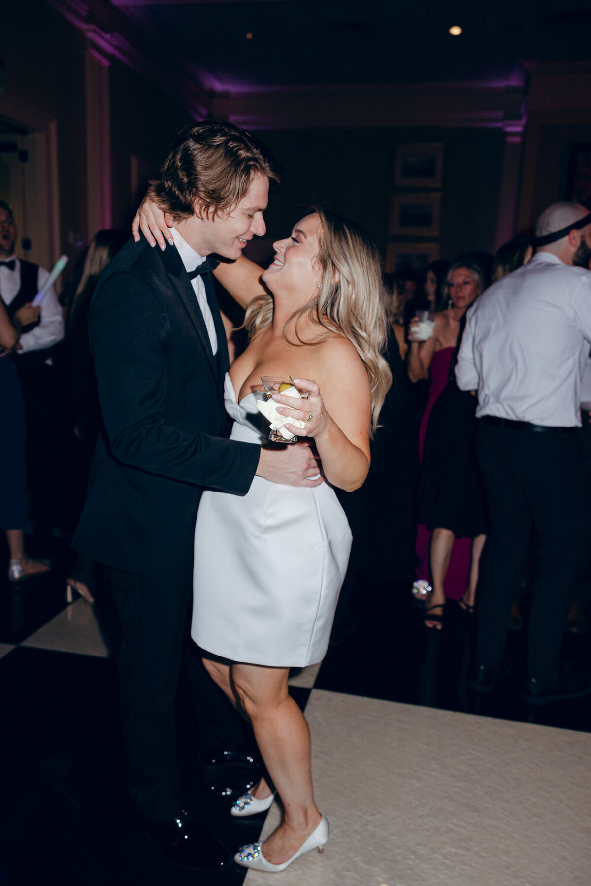 A wedding photo oft he bride and groom dancing during the wedding reception