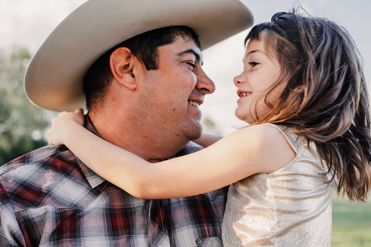 A cute laugh between father and daughter.