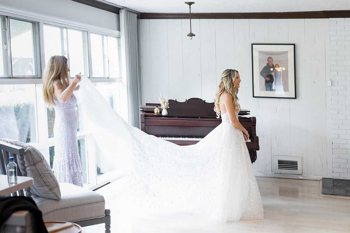 Bride having her dress fitted on her wedding day