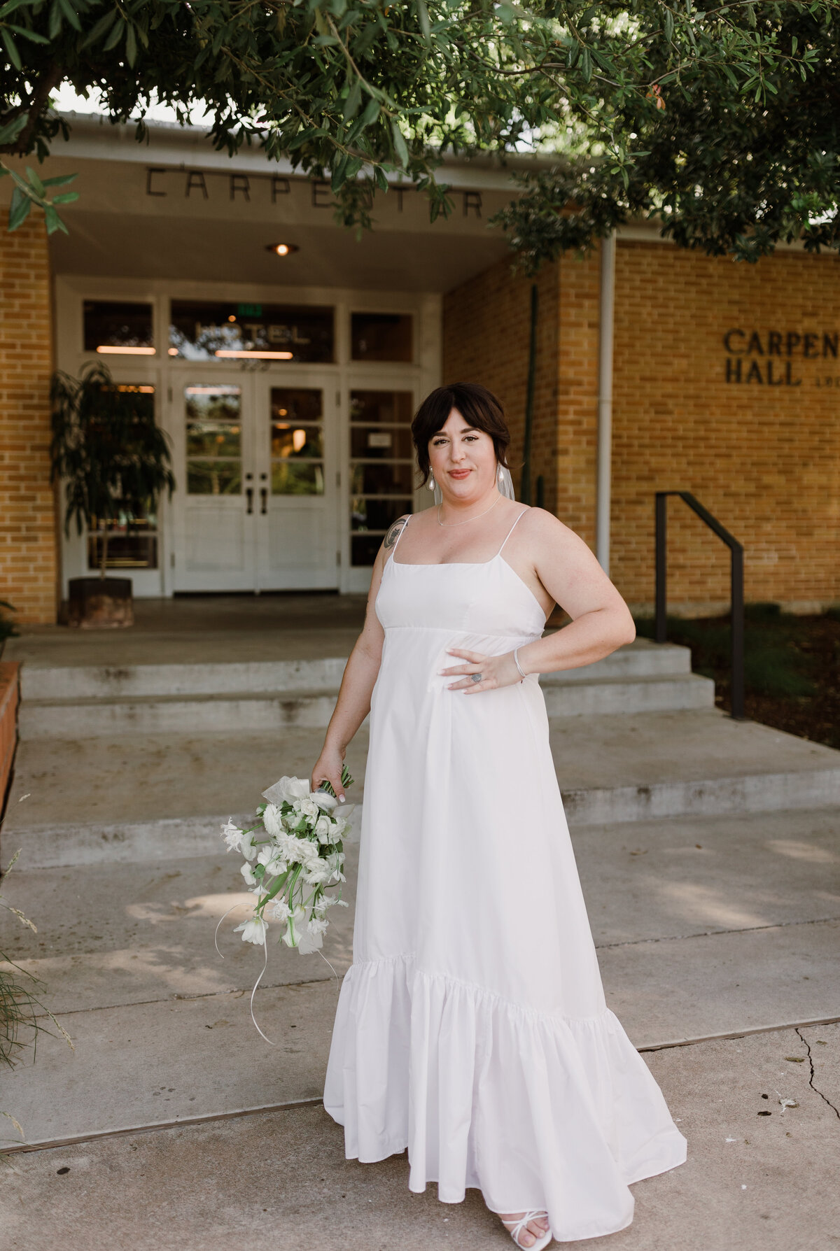 Bride standing outside the Bride and groom portraits at  Carpenter Hotel, Austin
