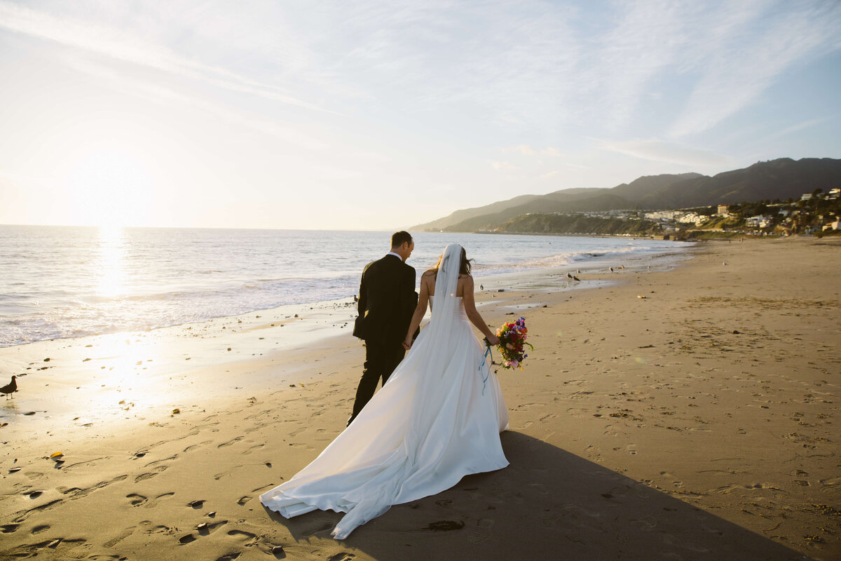 Bride and groom post wedding pictures outside of Bel Air Bay Club on the beach