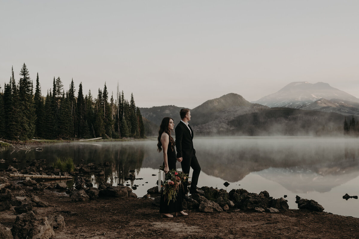 Bride and groom standing on top of Rattlesnake Ledge in Snoquamie National Forest