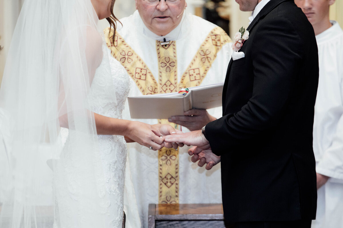 Exchanging rings during wedding ceremony.
