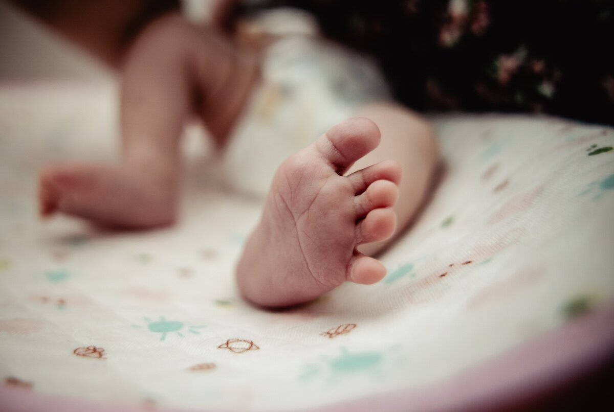 A closeup of a newborn baby's toes in her Edmonton home