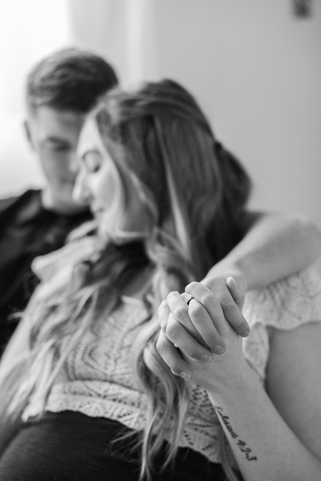Pregnant couple holding hands