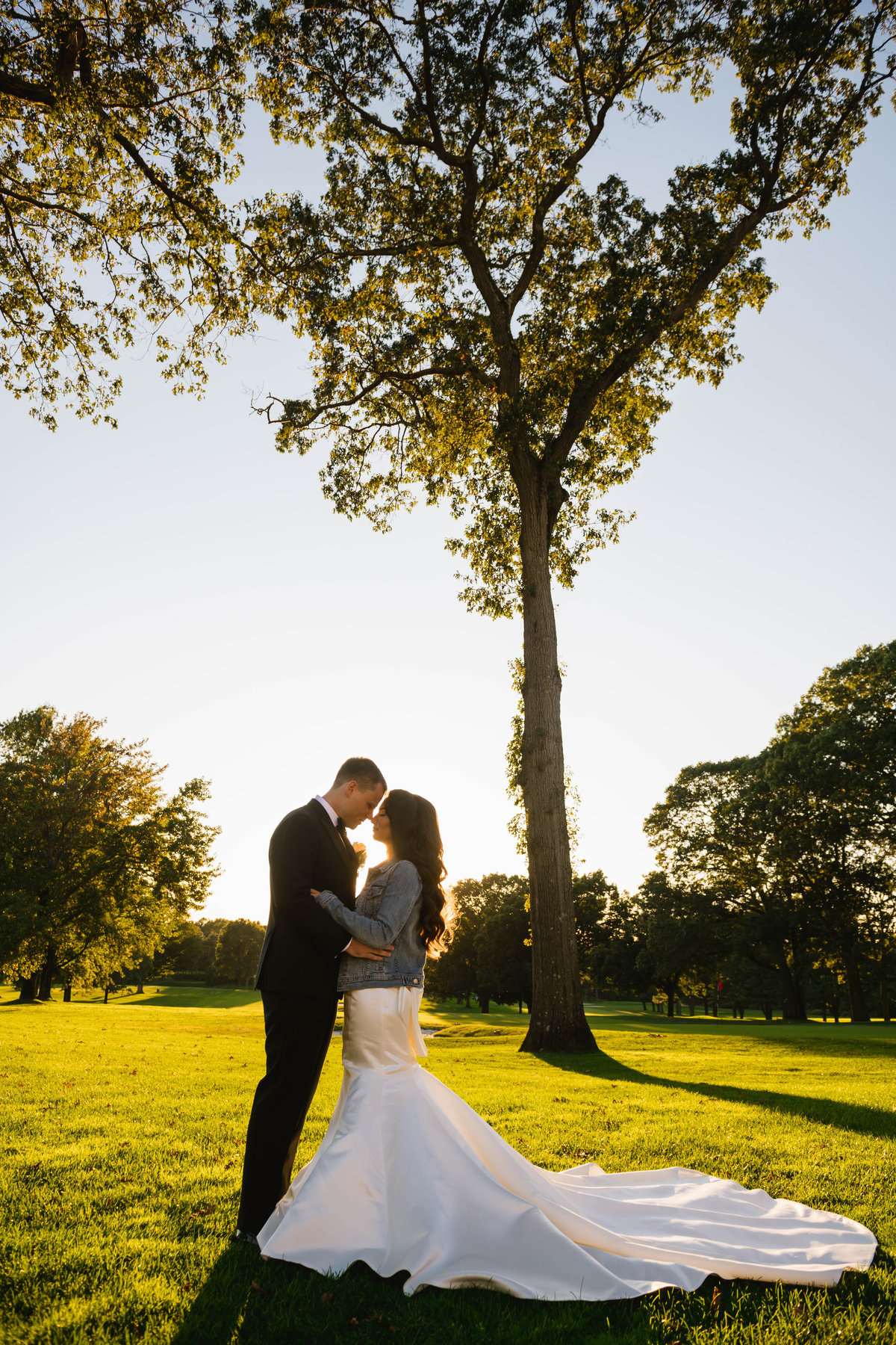 bride and groom photo looking into each others eyes on the golf course at The Muttontown Club