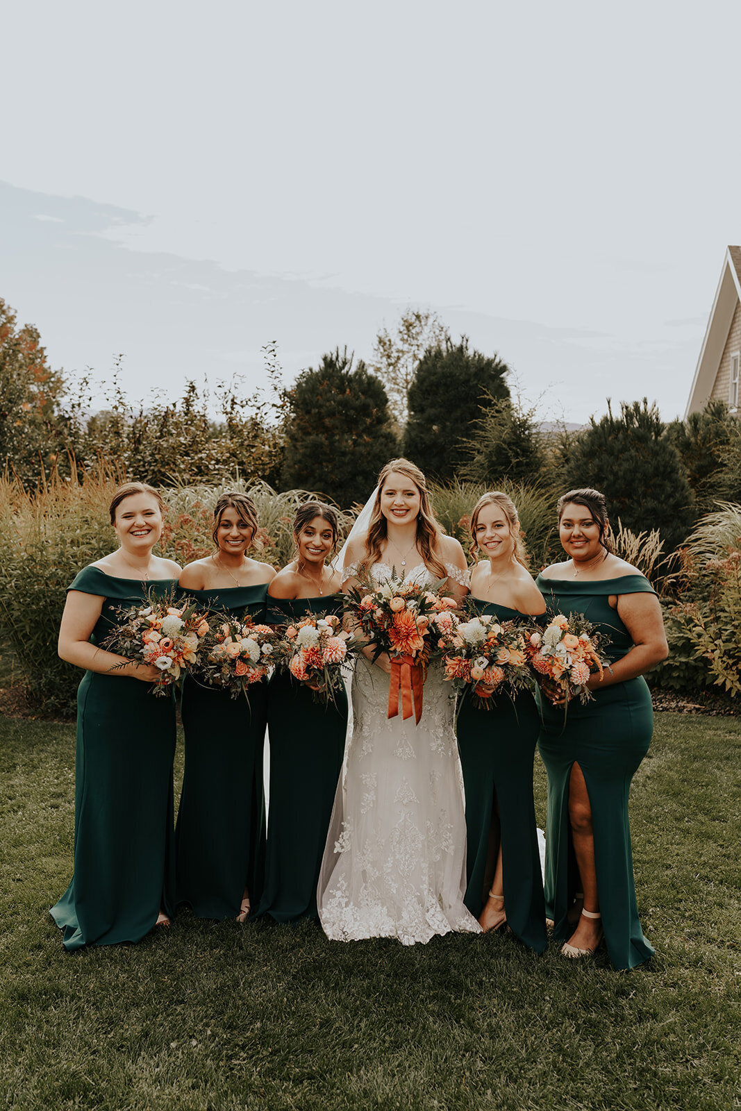 Deep green velvet dresses with terracotta and cream florals.