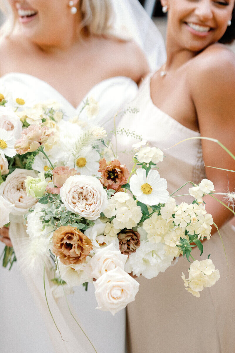 Bride holding flower arrangement by wedding planners in chicago
