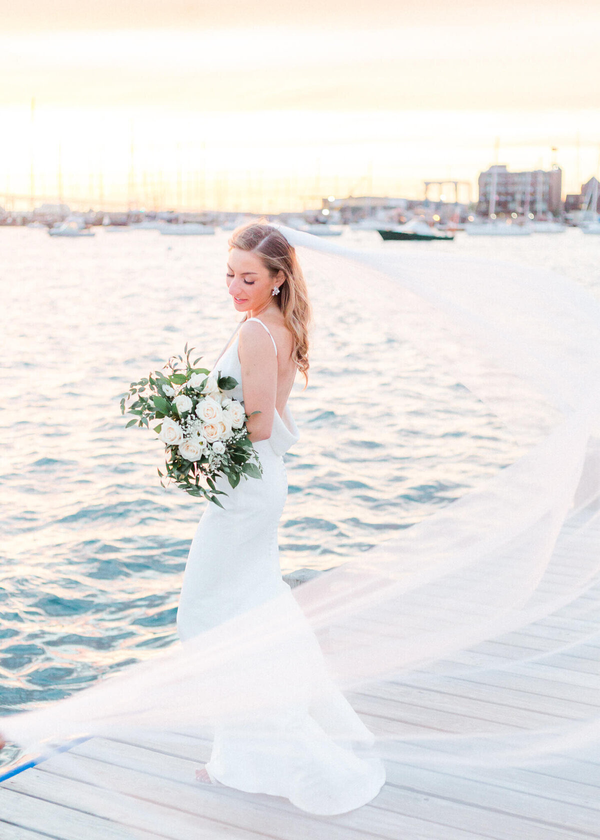 bride on dock at sunset at the bohlin newport wedding venue in RI