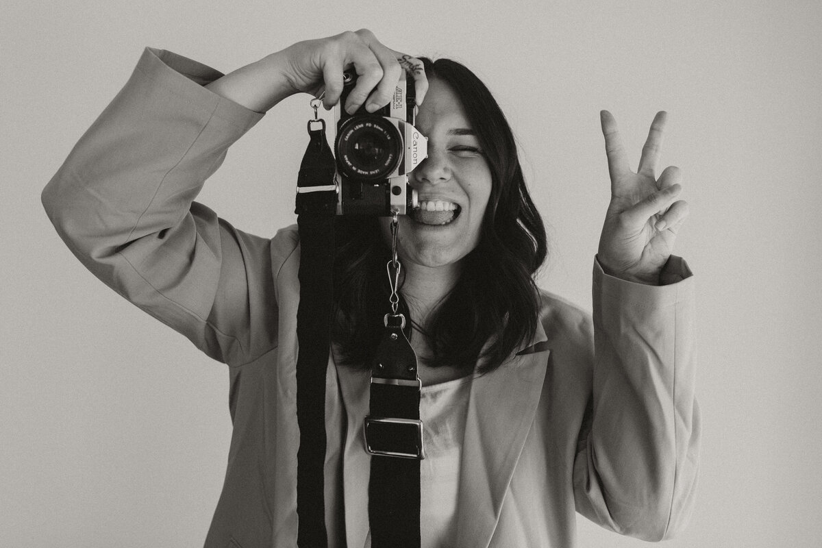 Danielle Dziedzic, photographer educator, holding camera