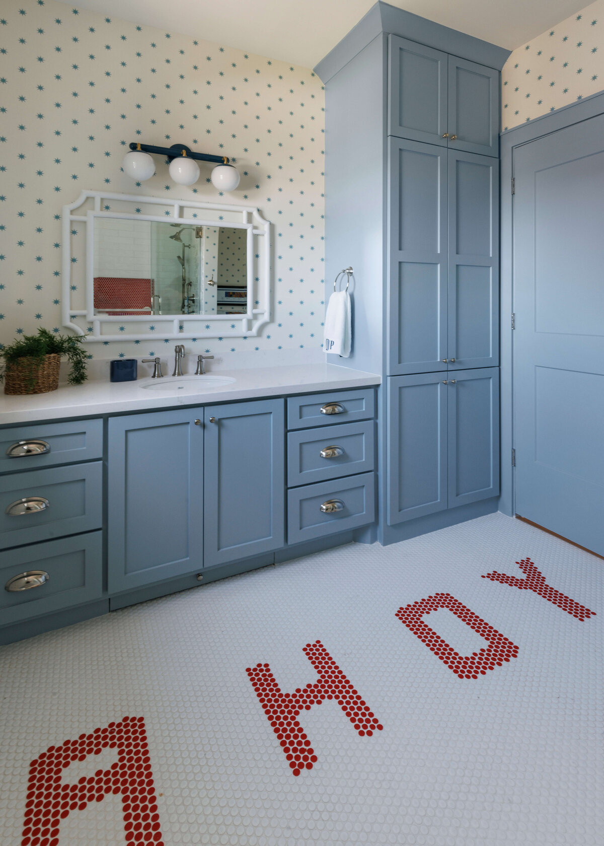 oyster creek studios lighthouse on the lake blue vanity and cabinets with a hoy red tiled pattern floor in bathroom