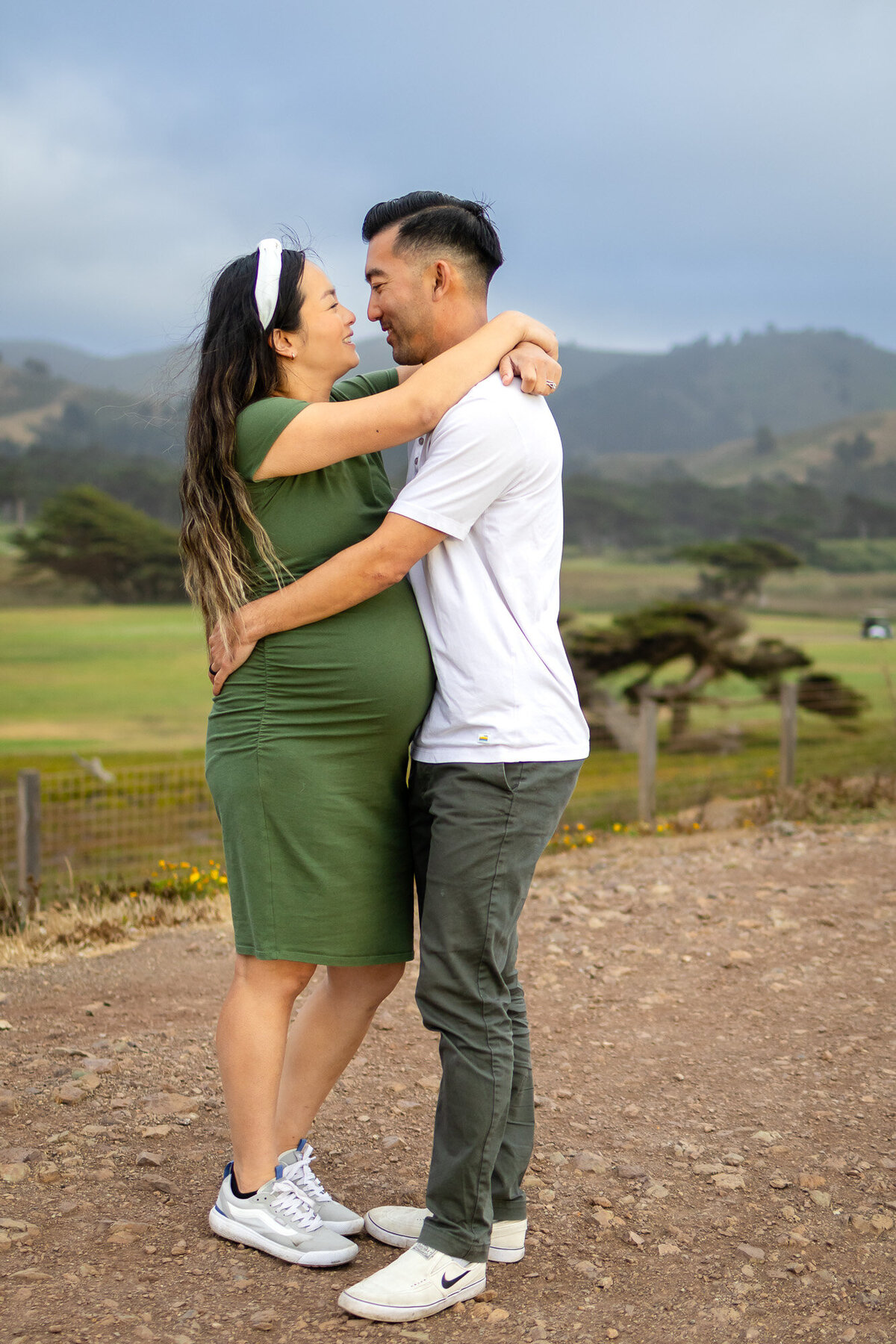 Bay Area Maternity Portfolio - Ellobelle Photography couple sharing sweet embrace on a mountain-view trail