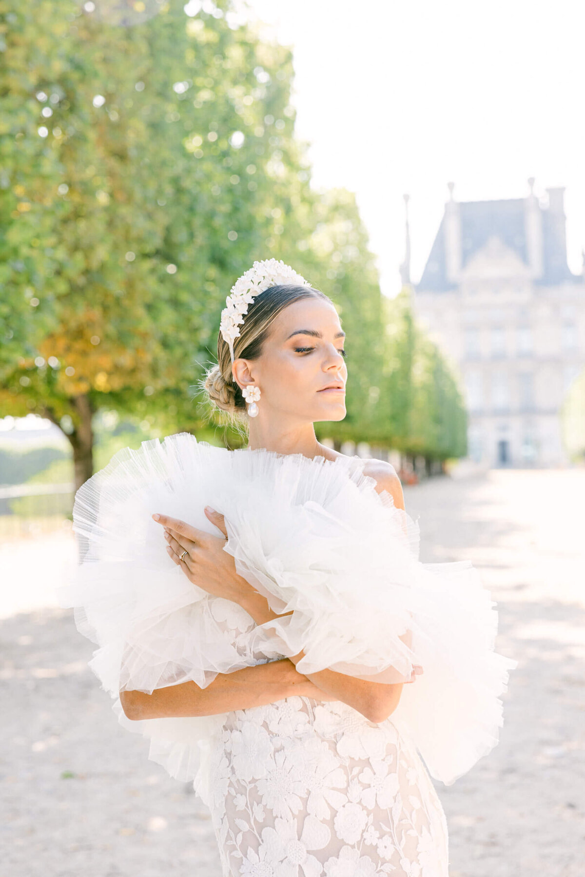 A wedding photo of a bride in her white dress in the streets of Paris in France.