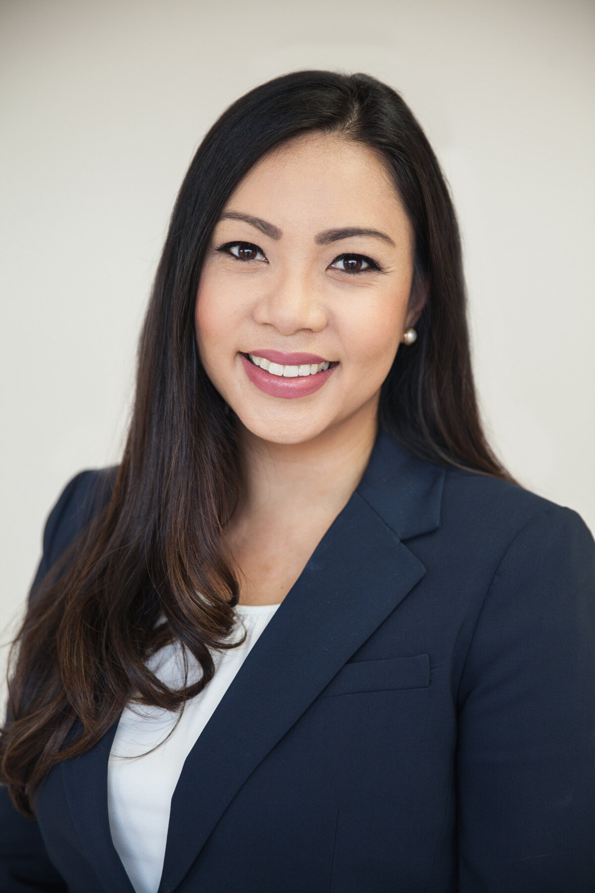 Headshot of a person in a blue blazer.