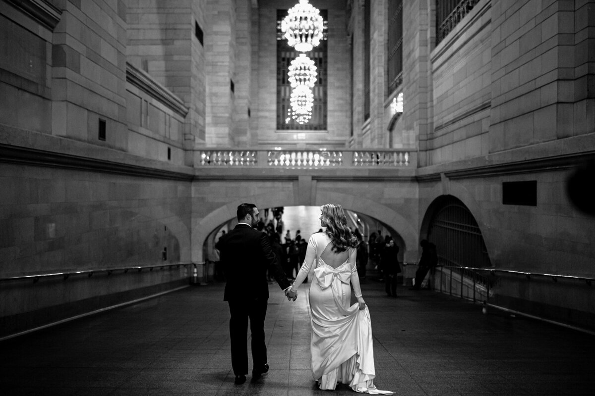 Bride and Groom walking down a tunnel.