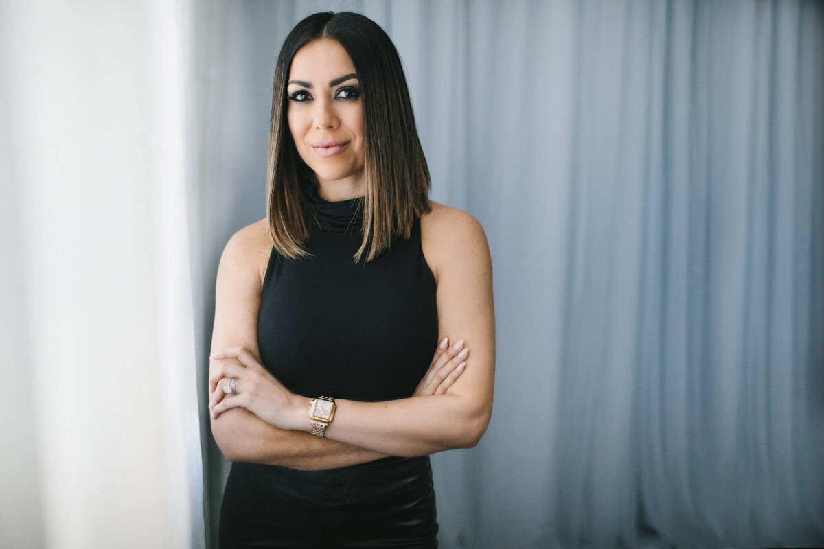 branding portrait of woman posing with arms crossed wearing black outfit